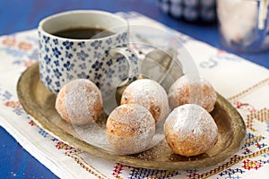 Vanilla krapfen doghnut with coffee. Rustic style.