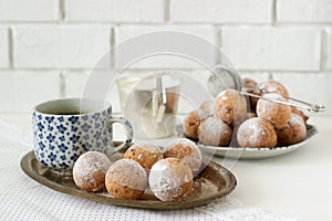 Vanilla krapfen doghnut with coffee. Rustic style.