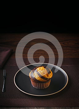 Vanilla Muffin with chocolate marbled in brown paper. Copy space