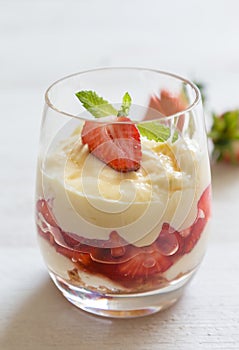 Vanilla pudding with tipsy strawberries on wood photo
