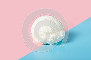 vanilla scoop of sundae ice cream on blue and pink background, close up