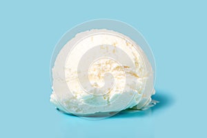 vanilla scoop of sundae ice cream isolated on blue background, close up
