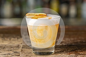 Vanilla Sour cocktail with egg white and lemon juice  on the bar