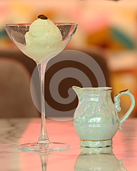 Vanilla sundae ice cream in glass cup with chocolate topping on table at restaurant background. sweet food concept