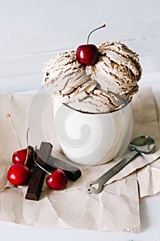 Vanilla sundae ice cream with sweet cherry and chocolate in cup