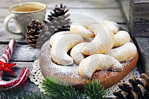 Vanillekipfer cookies. Amanda crescents Christmas cookies, powdered sugar dressing, cup of coffee, new year decoration