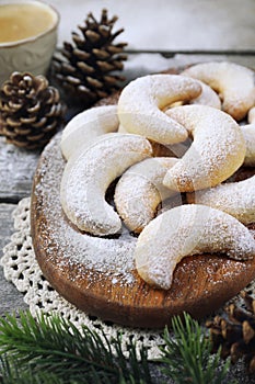 Vanillekipfer cookies. Amanda crescents Christmas cookies, powdered sugar dressing, cup of coffee, new year decoration