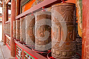 Vanishing point perspective of large prayer wheels in a Tibetan monastery, Xining, China