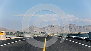 Vanishing point on road with mountains in the background