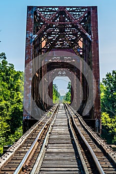 Vanishing Point View of an Old Railroad Trestle with an Old Iron Truss Bridge Over the Brazos River
