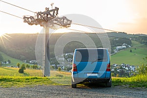 Vanlife. Old blue bus van is parking in front of landscape