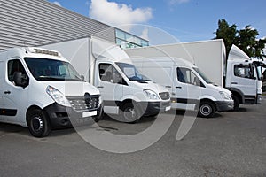 vans and trucks parked in parking lot for sale