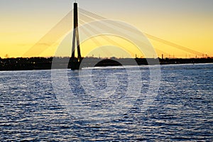 Riga, Latvia. Vansu bridge over the Daugava river, Western Dvina, at sunset.