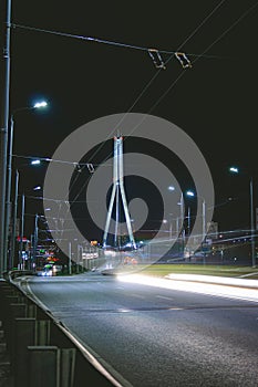 Vansu bridge in Riga, Latvia during night with traffic on it. Vansu bridge is a is a cable-stayed bridge that crosses the Daugava