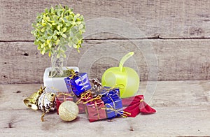 Vantage look Christmas decorations with red ball,green ball,red ribbon,bell,small tree on white pot, and artificial flower. aged a