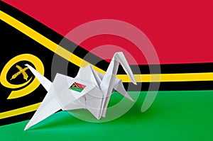 Vanuatu flag depicted on paper origami crane wing. Handmade arts concept