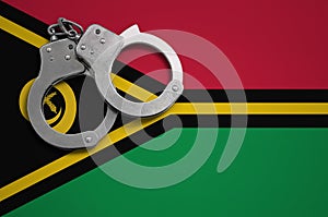 Vanuatu flag and police handcuffs. The concept of crime and offenses in the country