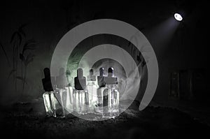 Vape concept. Smoke clouds and vape liquid bottles on dark background. Light effects. Useful as background or vape advertisement.