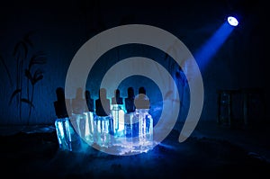 Vape concept. Smoke clouds and vape liquid bottles on dark background. Light effects. Useful as background or vape advertisement.