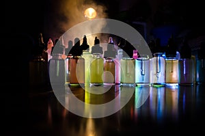 Vape concept. Smoke clouds and vape liquid bottles on dark background. Light effects. Useful as background or vape advertisement o