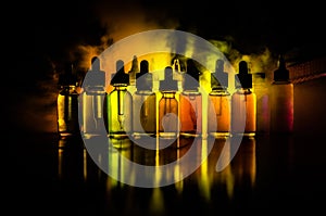 Vape concept. Smoke clouds and vape liquid bottles on dark background. Light effects. Useful as background or vape advertisement o