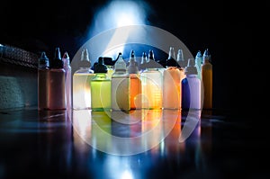 Vape concept. Smoke clouds and vape liquid bottles on dark background. Light effects. Useful as background or vape advertisement o