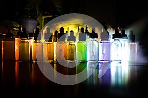 Vape concept. Smoke clouds and vape liquid bottles on dark background. Light effects. Useful as background or vape advertisement o