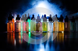 Vape concept. Smoke clouds and vape liquid bottles on dark background. Light effects. Useful as background or vape advertisement o