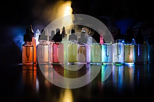 Vape concept. Smoke clouds and vape liquid bottles on dark background. Light effects. Useful as background or vape advertisement o