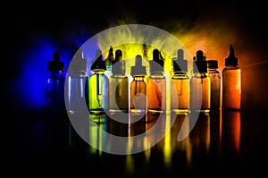 Vape concept. Smoke clouds and vape liquid bottles on dark background. Light effects. Useful as background or vape advertisement o