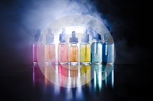 Vape concept. Smoke clouds and vape liquid bottles on dark background. Light effects. Useful as background or vape advertisement o