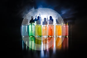 Vape concept. Smoke clouds and vape liquid bottles on dark background. Light effects. Useful as background or vape advertisement o