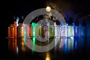 Vape concept. Smoke clouds and vape liquid bottles on dark background. Light effects. Useful as background or vape advertisement o