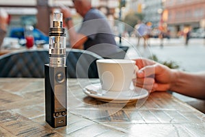 Vape or electronic cigarette and e-liquid on the table