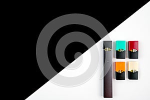 Vaping device and colored vaping pods on black and white diagonal background.
