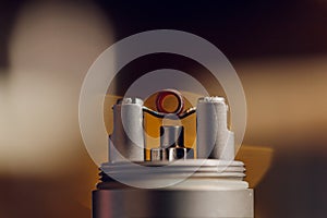 Vaping device with a hot spring on a black background for evaporation.