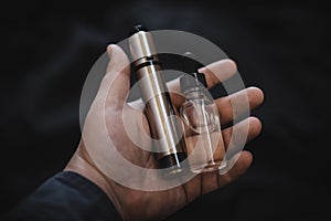 Vaping device in in the man`s hand. Electronic cigarette, vape