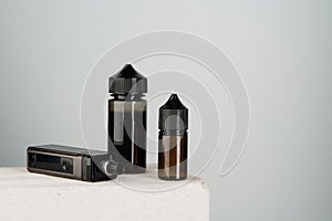 Vaping refill liquid bottle against gray background