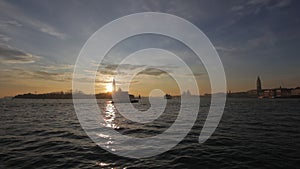 Vaporetto passing in the San Marco basin at sunset, Venice, Italy