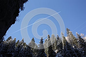 Vapour trail through snowy Dolomites