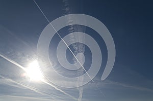 Vapour trails in sunny sky