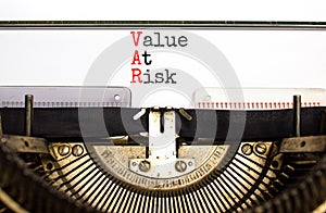 VAR Value at risk symbol. Concept words VAR Value at risk typed on beautiful retro old typewriter. Beautiful white background.