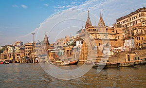Varanasi city with old architectural buildings and ancient temples along the Ganges river ghat