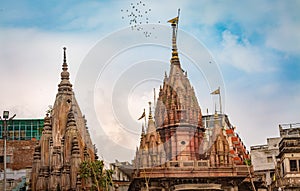 Varanasi city skyline near Ganges river ghat with ancient temples.