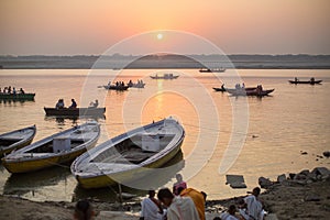 Pilgrims on boat floating on the waters of sacred river Ganges early morning.