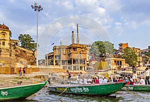 people cross the ganges by ferry