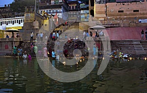 Varanasi, India: Hindu Family and friends take an early morning dip in the Ganges at Varanasi to pray and wash