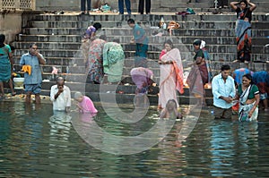 Varanasi, India : Hindu Family and friends take an early morning dip in the Ganges at Varanasi to pray and wash