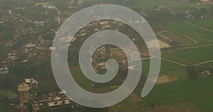 Varanasi, India. View From Airplane Window On View of the Benares villages. Houses are adjacent to green fields. Village