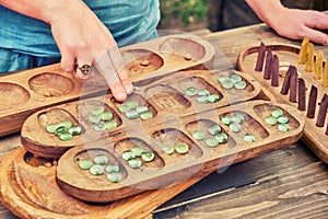 Vari Ovare is a board logic game for two from the family of mancala games. People play an ancient board game of the Mancala,